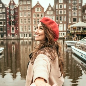 Amsterdam solo traveler holding hands.